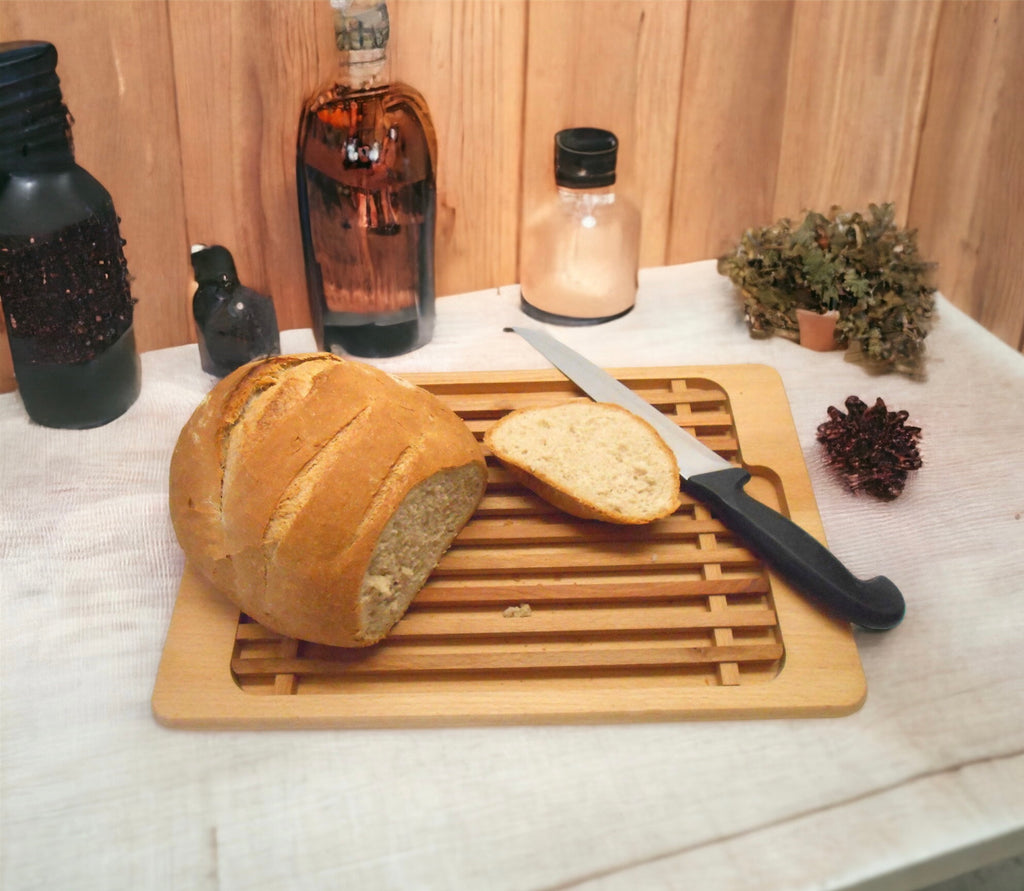 This cutting board has a guide to help you get even slices of bread and  also has a space underneath that catches all the crumbs. No one around here  is impressed! Surely